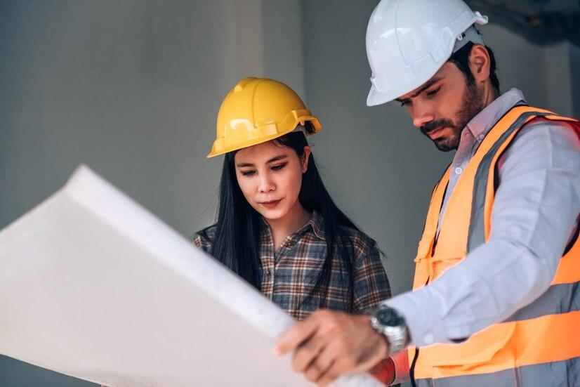 civil-engineer-construction-worker-manager-holding-digital-tablet-blueprints-talking-planing-about-construction-site-cooperation-teamwork-concept_640221-168